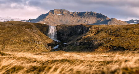 Wonderful nature of Iceland. fresh green grass and icelandic moss near river with waterfall. Typical Icelandic scenery of summer. Picture of wild area. Amazing Icelandic landscape. Natural background