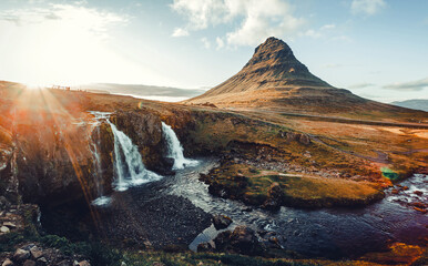 Scenery of Icelandic nature with sunlight. Picturesque landscape with famous Kirkjufell mountain...
