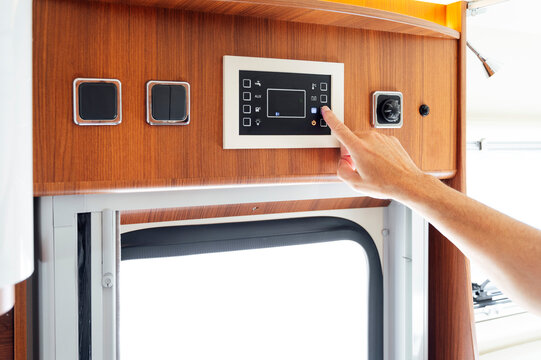 Hand Of Man Pressing Button On Motor Home Control Panel