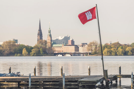 Germany, Hamburg,ÔøΩFlag of Hamburg attached to small jetty on shore ofÔøΩOuter Alster Lake