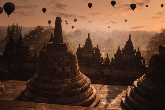 Indonesia, Central Java, Magelang, Silhouettes of hot air balloons flying over Borobudur&Ocirc;&oslash;&Omega;temple at dusk