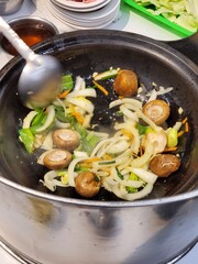 Stirring traditional hot pot in Taiwan