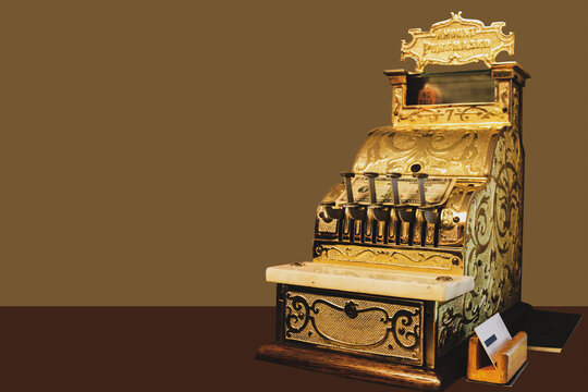 Fancy Golden Ornate Cash Register On Counter With Bill Laid On It And Business Card Holder And Ledger Next To It On Counter - Room For Copy