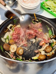 Stirring traditional hot pot in Taiwan