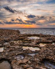 Fototapeta na wymiar Small pools reflecting the cloudy sky during sunset