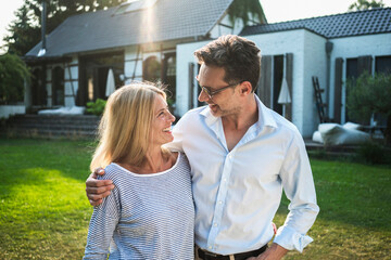 Happy couple in the garden of their country house