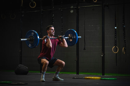 Man doing overhead squat exercise at gym