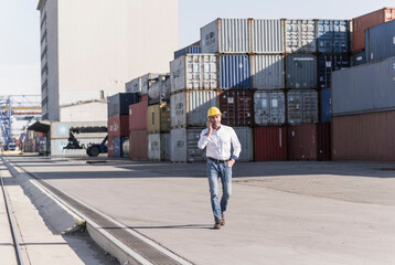Businessman on the phone at industrial site