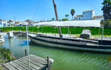 Pier and fishing boats in the lagoon "La Albufera", in Valencia, Spain