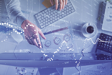 Double exposure of man's hands typing over computer keyboard and data theme hologram drawing. Top view. Technology concept.