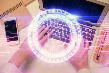 Double exposure of woman hands working on computer and blockchain theme hologram drawing. Top View....