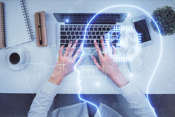 Double exposure of woman working on computer andhuman brain hologram drawing. Top View. Ai concept.