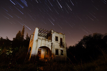 A view of the stars of the Milky Way with a mountain top in the foreground. Night sky nature summer...