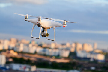drone with digital camera flying at city street