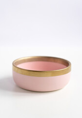 New luxury bowl plate view from above on a isolated white background. Top view. Porcelain pink saucer with gold ring. Trendy Coral tones. Flat lay view.