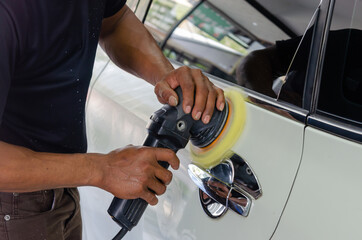 Man hands holding the work tool polish the car.Buffing and polishing car. Car detailing.