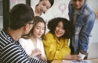 Asian creative team sitting and working sharing creative ideas inspire in workshop together. Business people are meeting at creative office workplace.