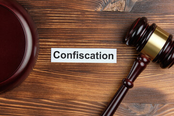 The word confiscation on a white sticker next to the judge hammer
