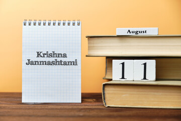 11th august - Krishna Janmashtami, indian holiday. Eleventh day month calendar concept on wooden blocks with copy space.