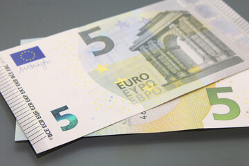 Five euro banknote on dark background