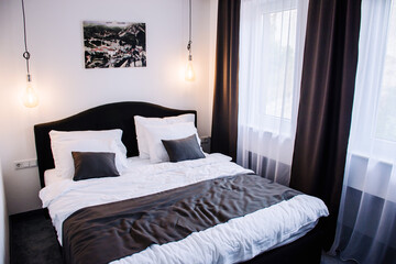 A nicely organized bright hotel room with a king sized bed