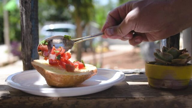 Season the bruschetta with oil tomatoes onion garlic and basil