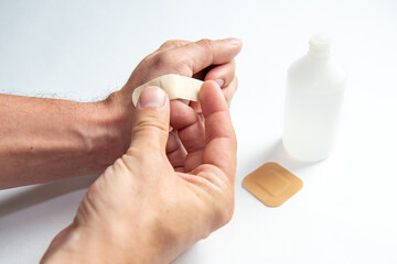 disinfecting the wound on the hand and applying a patch