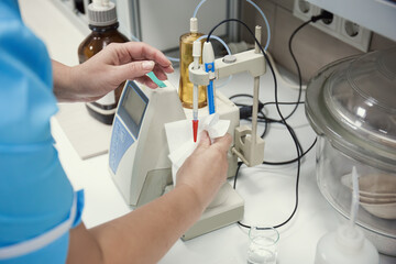 Laboratory worker hands with lab equipment making tests, food factory checking or medical virus research.