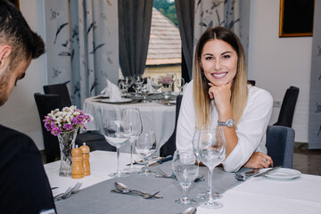 Woman smiling while her partner is looking down picking what they are going to eat