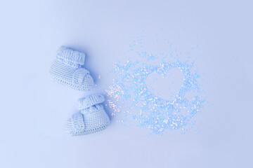 Baby shoes, booties on pink background, first newborn party background, birthday, expectation of newborn, motherhood, maternity, parenthood, minimal monochrome card, banner, copy space