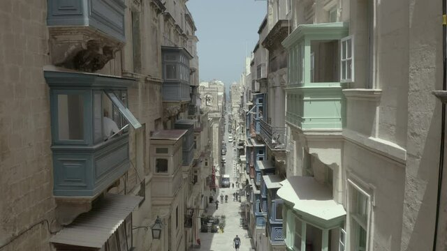 Drone flying forward on narrow beautiful old street, Valletta, Malta. Old, vintage windows, balconies. - 4K stock video
Europe, Malta, Valletta, City, Street