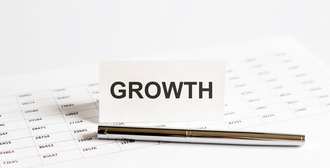 Text GROWTH on stickers,pen on the background of documents. Financial bookkeeping, Accounting Concept. Top view.