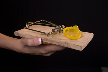 Female holding a mousetrap with a confom in it