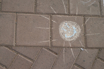 chalk drawn sun on the pavement
