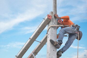 Workers, electrician who climb pole, install new equipment, work on electric pole, electric pole