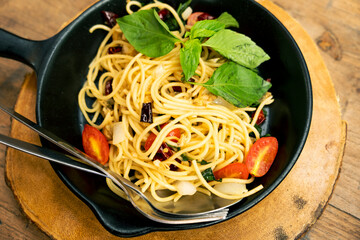 Clam Spaghetti in a Frying Pan on a Wooden Table