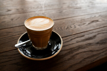 Hot latte on a wooden table