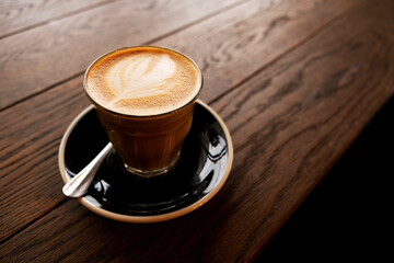 Hot latte on a wooden table