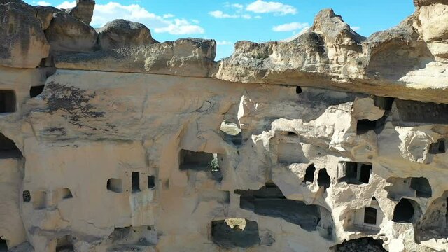 Aerial view of Cavusin-Cappadocia A lot of stone houses and churchs. ancient village Cavusin. turkey tourism trip. aerial shooting drone. in Nevsehir Turkey fairy chimneys zoom out shooting