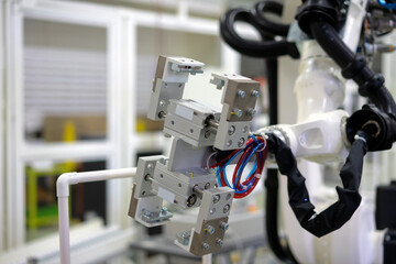 Factory 4.0 concept: View of gripper unit on handerling robot arm of automation machine.