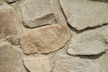 Stone wall texture background - grey stone siding with different sized stones