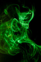 Green smoke motion on black background.