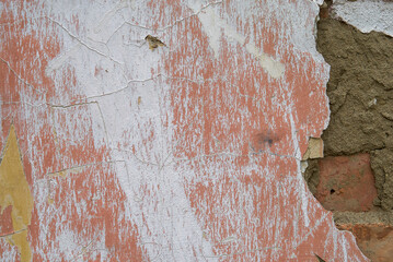 Texture of an old plastered and red painted wall