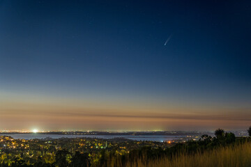 Comet NEOWISE in the early night sky over Folsom Lake in Folsom California. 