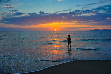 Fototapeta premium Sunset Ocean Man