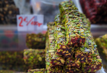 Selection of turkish delight or rahat lokum candy on display at an outdoor farmer's market in...