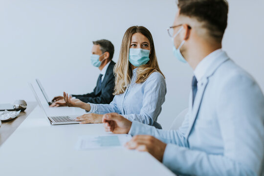 Group of business people have a meeting and working in office and wear masks as protection from corona virus