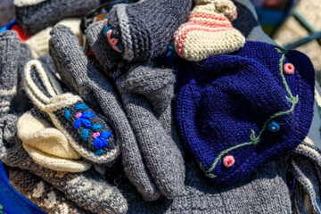 Hand knitted wool socks, slipers and hats at an outdoor market in old town Kotor, Montenegro