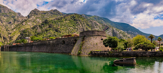 Fototapeta na wymiar Panorama of Kotor Bay or Boka Kotorska, mountains and the ancient stone city wall of Kotor old town former Venetian fortress in Montenegro