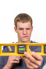Young man eyeing a hand level- a series